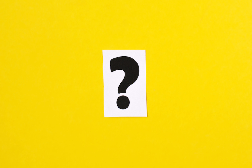 Yellow background, white square and black question mark representing FAQs about emergency electrician.