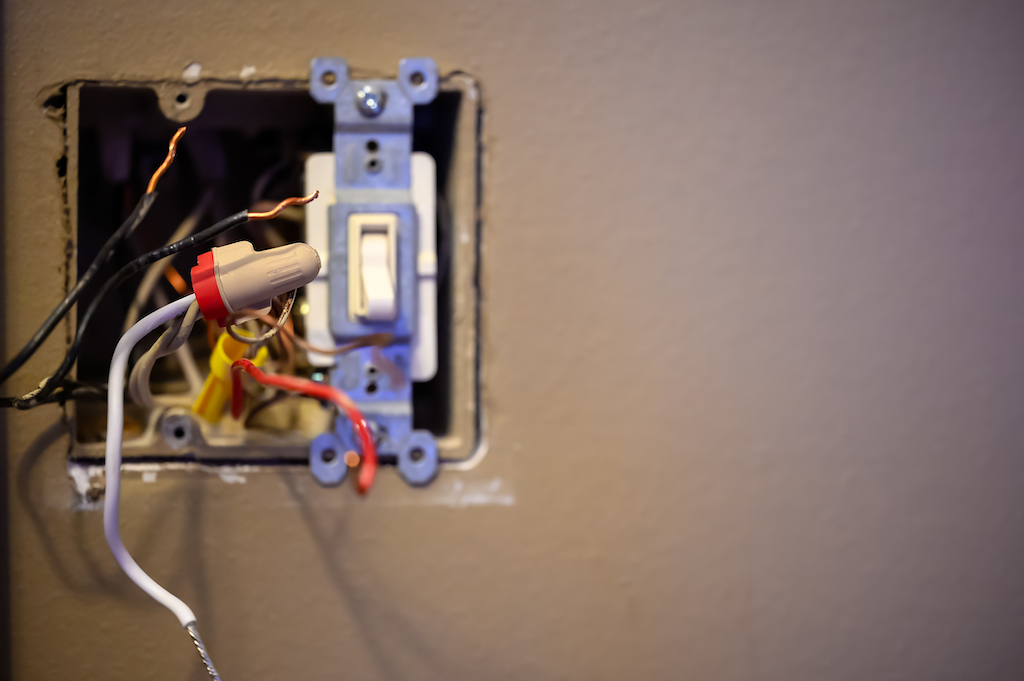 Loose wires and a light switch in exposed wall. | Electrical services 